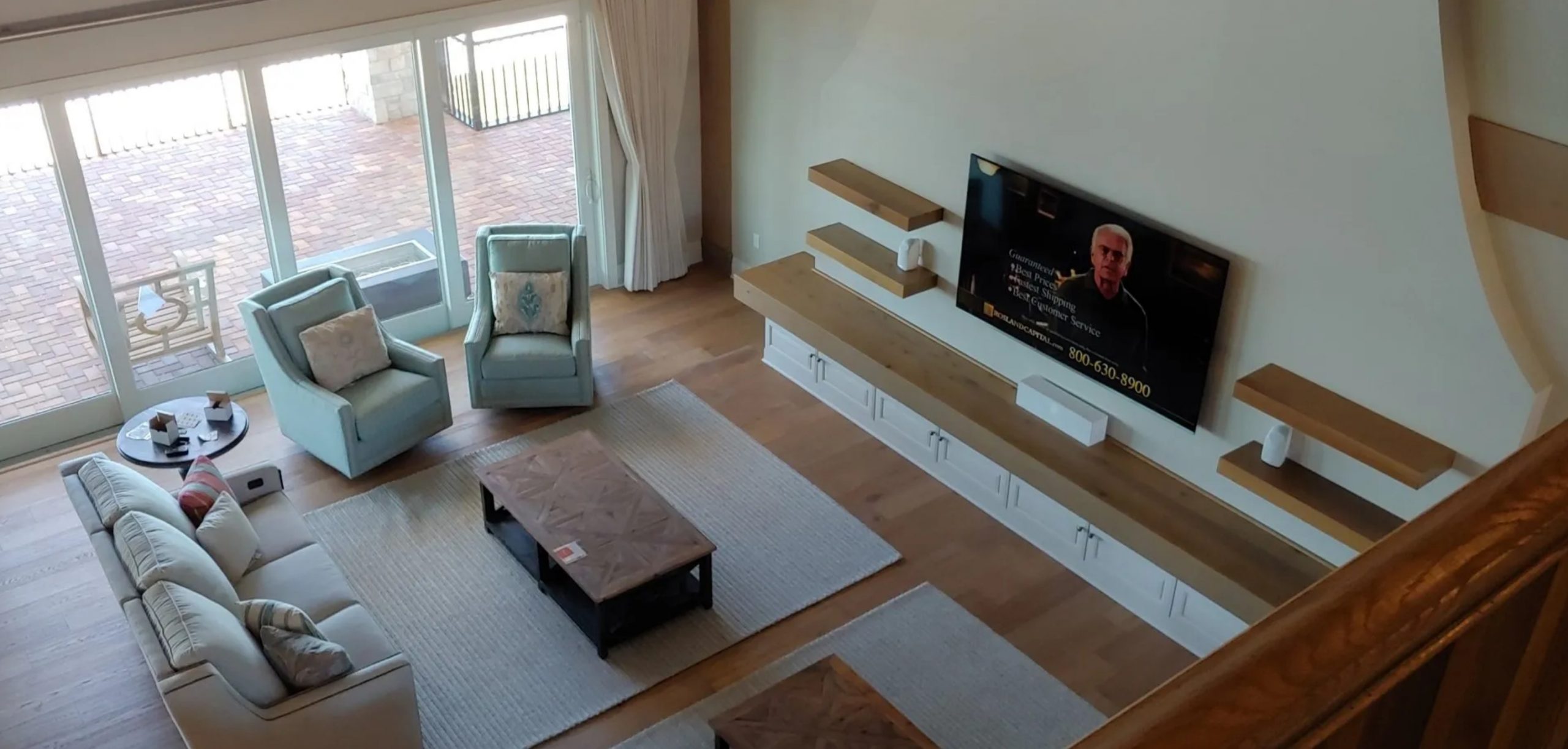 Large living room with television mounted on wall